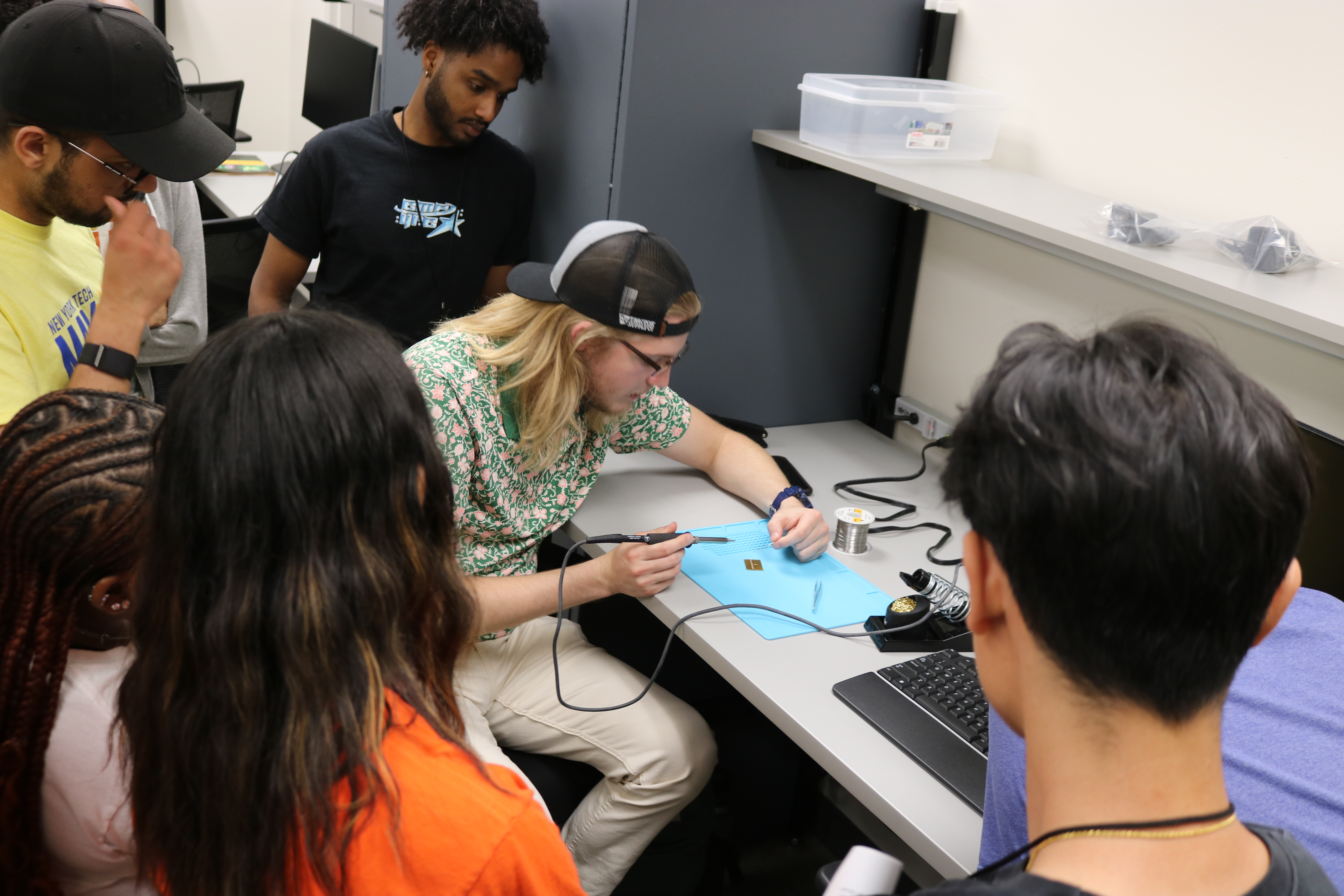 Student learning how to solder at Spectrum Sizzle